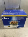 Oster 6.1 Quart Double Tiered Steamer In White, Model 5712, New. Fixed Price $100.00.