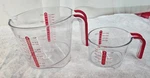 Pair Plastic Progressive Liquid 4 & 1 Measuring Cups W Handles. Fixed Price $22.47.